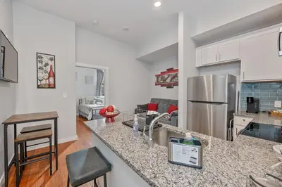 a kitchen and living room with a counter top at OTR's Hidden Gem in Cincinnati
