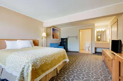 a hotel room with a bed and a television at Days Inn by Wyndham Fairmont in Fairmont
