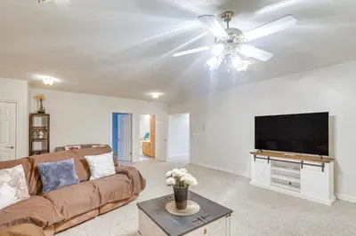 a living room with a couch and a flat screen tv at 6 Mi to Town Peaceful Lima Home! in Lima