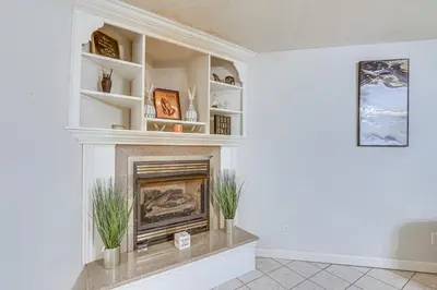 a living room with a fireplace with white shelves at 6 Mi to Town Peaceful Lima Home! in Lima