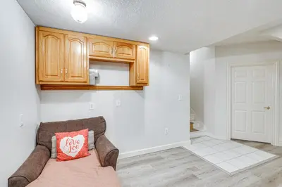 a living room with a couch and wooden cabinets at 6 Mi to Town Peaceful Lima Home! in Lima
