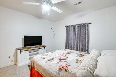 a bedroom with a bed and a flat screen tv at 6 Mi to Town Peaceful Lima Home! in Lima