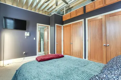 a bedroom with a bed with a red pillow on it at Less Than 1 Mi to Wittenberg Eclectic Loft with Parking! in Springfield
