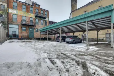 a snow covered parking lot in front of a building at Less Than 1 Mi to Wittenberg Eclectic Loft with Parking! in Springfield