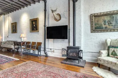 a living room with a fireplace and a tv at Less Than 1 Mi to Wittenberg Eclectic Loft with Parking! in Springfield
