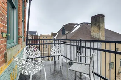 three white chairs sitting on a balcony at Less Than 1 Mi to Wittenberg Eclectic Loft with Parking! in Springfield