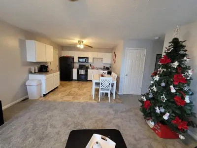 a living room with a christmas tree and a kitchen at Overbrook Delight -tranquil stay for day and night in Monroe