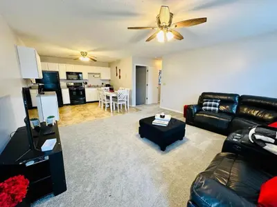 a living room with a couch and a ceiling fan at Overbrook Delight -tranquil stay for day and night in Monroe