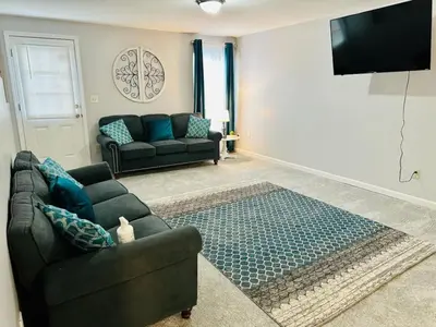 a living room with a couch and a tv at Overbrook Delight -tranquil stay for day and night in Monroe