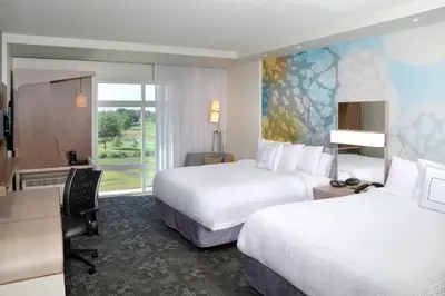 a hotel room with two beds and a desk at Courtyard by Marriott Youngstown Canfield in Canfield