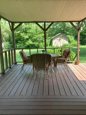 a wooden deck with a table and chairs on it at Dimmick Cozy Retreat 3 Bed 1 Bath - Sleeps 6 in Gano