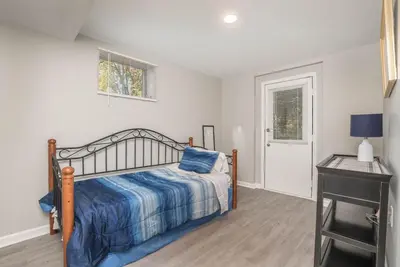 a bedroom with a bed and a table and a window at Ashwood Arbor 6 bed 3 bath sleeps 13 in Olde West Chester