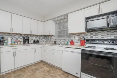 a kitchen with white cabinets and a stove top oven at Ashwood Arbor 6 bed 3 bath sleeps 13 in Olde West Chester