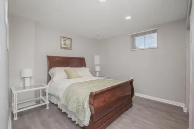 a white bedroom with a large bed and a window at Ashwood Arbor 6 bed 3 bath sleeps 13 in Olde West Chester