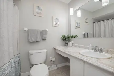 a white bathroom with a toilet and a sink at Ashwood Arbor 3 bed 2 bath sleeps 8 in Olde West Chester