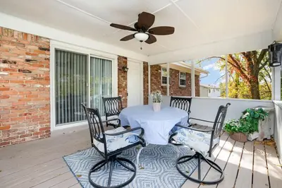 a porch with a table and chairs and a ceiling fan at Ashwood Arbor 3 bed 2 bath sleeps 8 in Olde West Chester