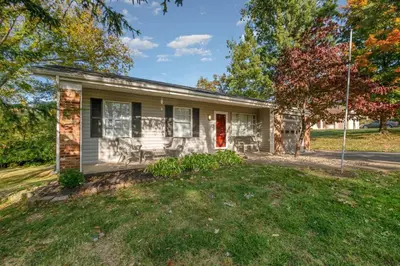 a small house with a red door on a yard at Ashwood Arbor 3 bed 2 bath sleeps 8 in Olde West Chester