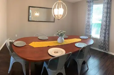 a dining room table with chairs and a vase on it at 4 Bed 2.5 Bath Sleeps 10- King of Karincrest in Middletown