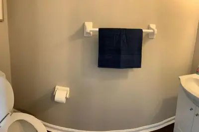 a bathroom with a blue towel hanging on the wall at 4 Bed 2.5 Bath Sleeps 10- King of Karincrest in Middletown
