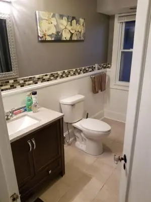 a bathroom with a white toilet and a sink at Middletown Centenarian 4 Bed 2 Bath Sleeps 12 in Middletown