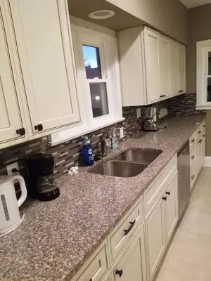 a kitchen with white cabinets and a sink at Middletown Centenarian 4 Bed 2 Bath Sleeps 12 in Middletown