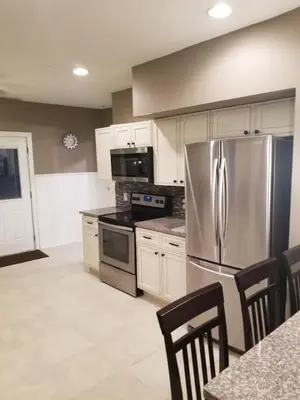a kitchen with a stainless steel refrigerator and appliances at Middletown Centenarian 4 Bed 2 Bath Sleeps 12 in Middletown