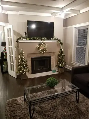 a living room with a fireplace and christmas trees at Middletown Centenarian 4 Bed 2 Bath Sleeps 12 in Middletown