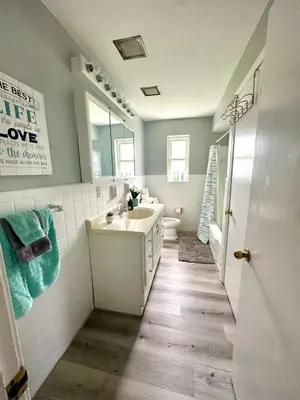 a bathroom with a sink and a toilet and a mirror at Hot tub bubbles on Butler in Mason