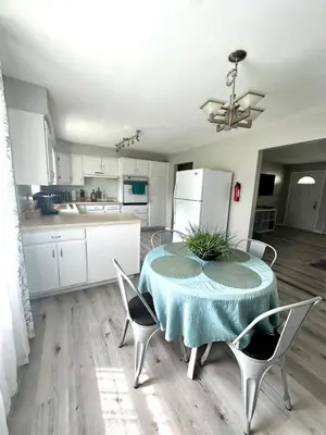 a kitchen and dining room with a table and chairs at Hot tub bubbles on Butler in Mason