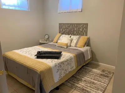 a bedroom with a bed with a tray on it at Lovely Retreat Backyard With Deck and entertain room in Mason