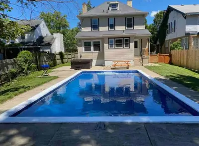 a swimming pool in the yard of a house at Main Street Oasis Pool and Hot Tub Sleeps 8 in Hamilton