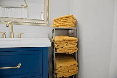 a bathroom with a towel rack next to a sink at Main Street Oasis Pool and Hot Tub Sleeps 8 in Hamilton