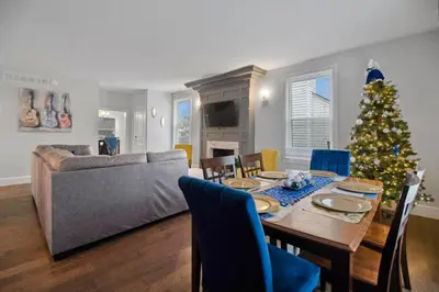 a living room with a table and a christmas tree at Main Street Oasis Pool and Hot Tub Sleeps 8 in Hamilton