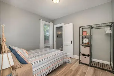 a bedroom with a bed and a mirror at Dayton Street Sports Haven - 3 Bed 2 Bath Sleeps 8 in Hamilton
