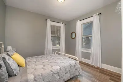 a bedroom with a bed and two windows at Dayton Street Sports Haven - 3 Bed 2 Bath Sleeps 8 in Hamilton