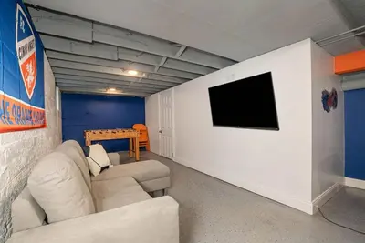 a living room with two couches and a flat screen tv at Dayton Street Sports Haven - 3 Bed 2 Bath Sleeps 8 in Hamilton