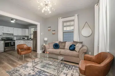 a living room with a couch and a glass table at Dayton Street Sports Haven - 3 Bed 2 Bath Sleeps 8 in Hamilton