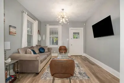 a living room with a couch and a tv at Dayton Street Sports Haven - 3 Bed 2 Bath Sleeps 8 in Hamilton
