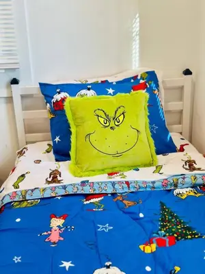 a bed with a pillow with a smiley face at Holly Jolly Historic Home Where Its Always XMAS in Hamilton