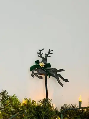 a christmas ornament of a reindeer on a pole at Holly Jolly Historic Home Where Its Always XMAS in Hamilton