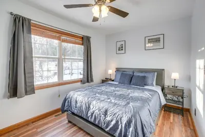a bedroom with a bed and a ceiling fan at Hocking Hills Hideaway Near Lake Logan in Logan
