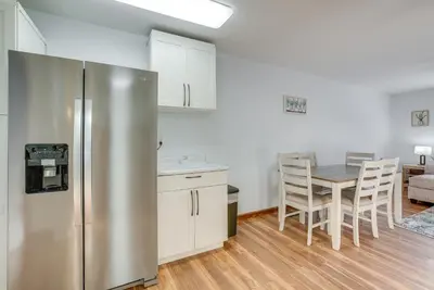 a kitchen with a stainless steel refrigerator and a table at Hocking Hills Hideaway Near Lake Logan in Logan