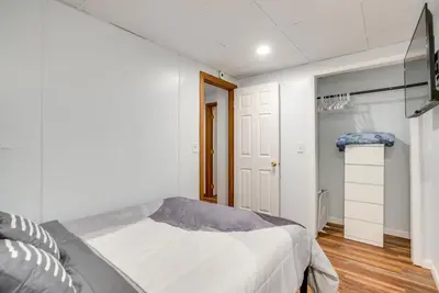 a white bedroom with a bed and a closet at Hocking Hills Hideaway Near Lake Logan in Logan