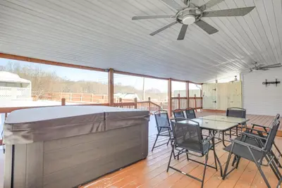 a patio with a table and chairs and a ceiling fan at Hocking Hills Hideaway Near Lake Logan in Logan