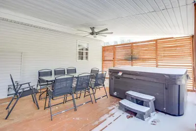 a patio with a table and chairs and a fan at Hocking Hills Hideaway Near Lake Logan in Logan