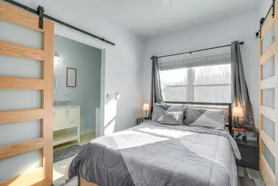 a bedroom with a large bed and a window at 4 Mi to Lake Logan Hocking Hills Apartment in Logan
