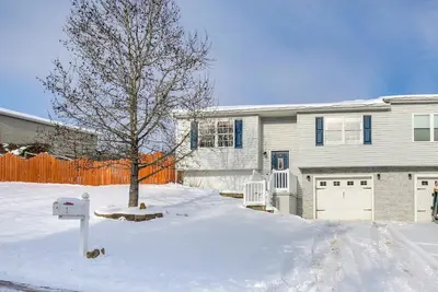 a house with a tree in the snow at 4 Mi to Lake Logan Hocking Hills Apartment in Logan