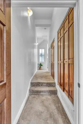 a hallway with wooden doors and stairs in a house at Penthouse Lofts on E 4th, Private Rooftop Patio in Cleveland