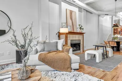a living room with a couch and a fireplace at Penthouse Lofts on E 4th, Private Rooftop Patio in Cleveland