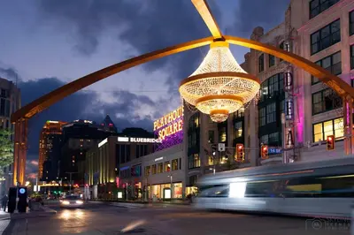 a large chandelier hanging over a city street at night at Penthouse Lofts on E 4th, Private Rooftop Patio in Cleveland